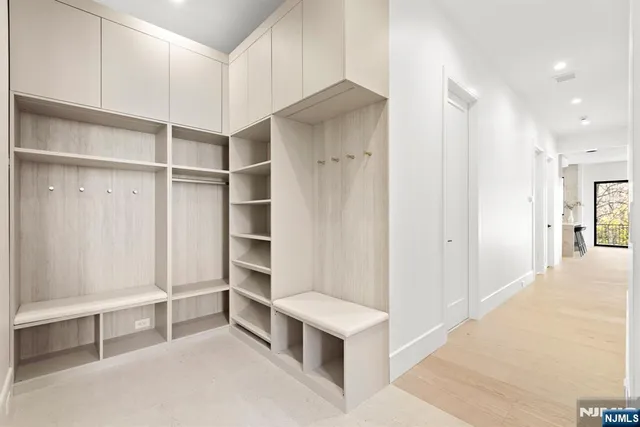 an empty room with windows and closet