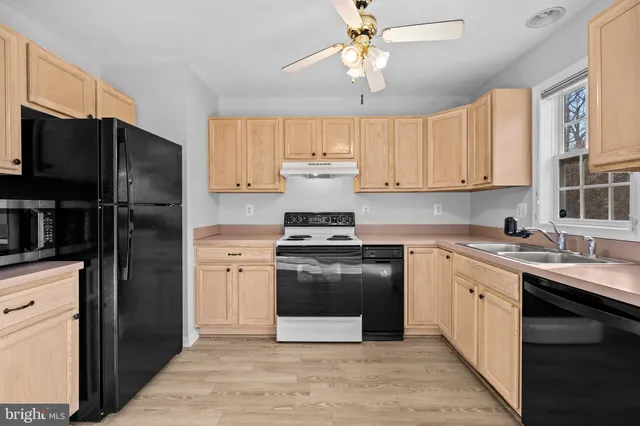a kitchen with a stove sink and refrigerator