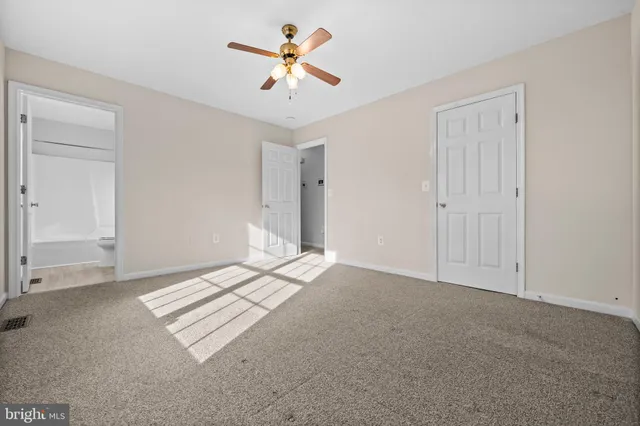 a view of empty room with ceiling fan