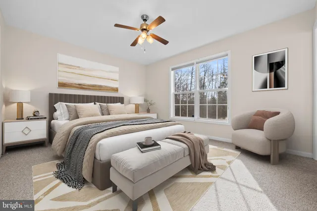 a bedroom with a bed a couch and a chandelier