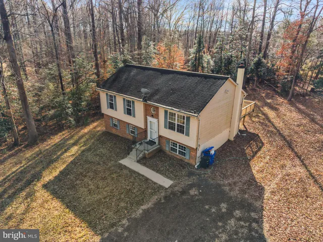 a view of house with a yard