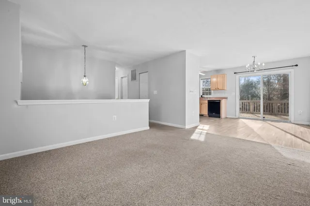 a view of an empty room with a fireplace and a window