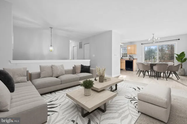 a living room with furniture and kitchen view