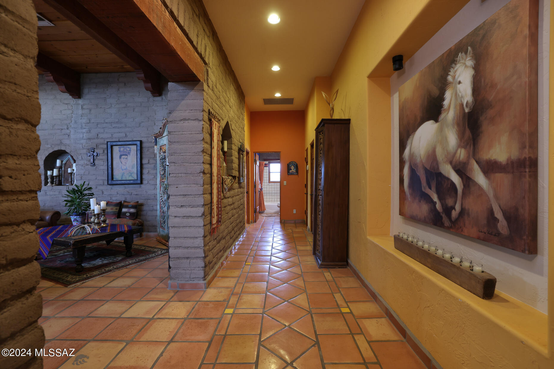11725 East Spanish Ridge Place Tucson, AZ 85730 - Photo 28 of 51 a hallway with a couch and a stove next to a window