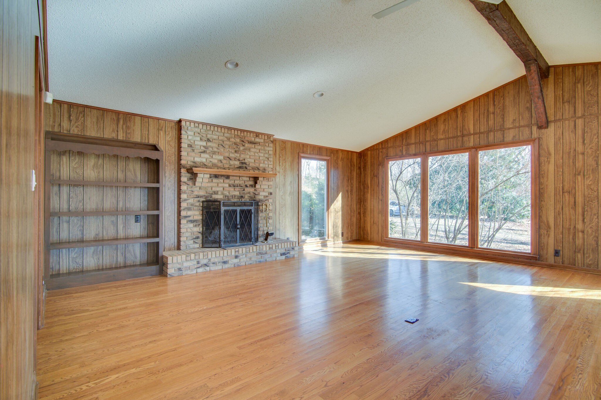 7325 Overby Road Fairview, TN 37062 - Photo 11 of 49 wooden floor fireplace and windows in an empty room