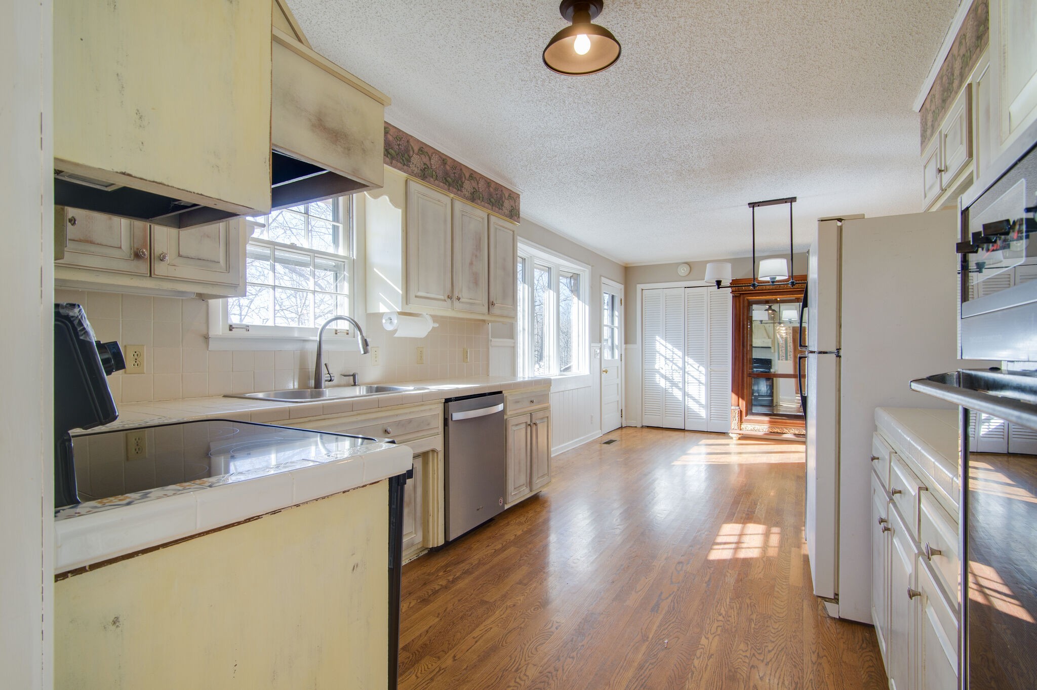 7325 Overby Road Fairview, TN 37062 - Photo 18 of 49 a kitchen that has a sink a stove and a wooden floor