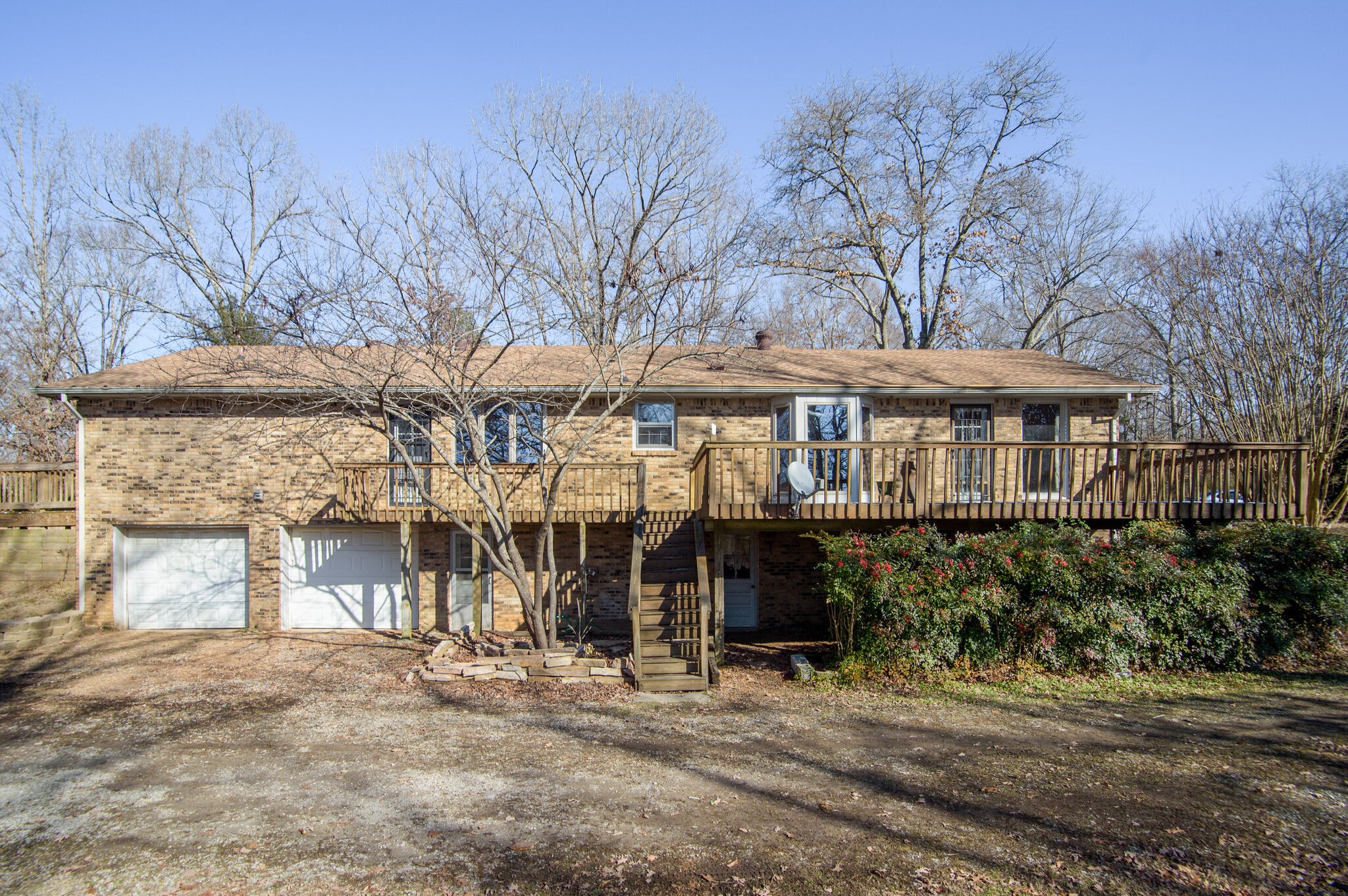 7325 Overby Road Fairview, TN 37062 - Photo 7 of 49 a front view of a building with a garden and trees
