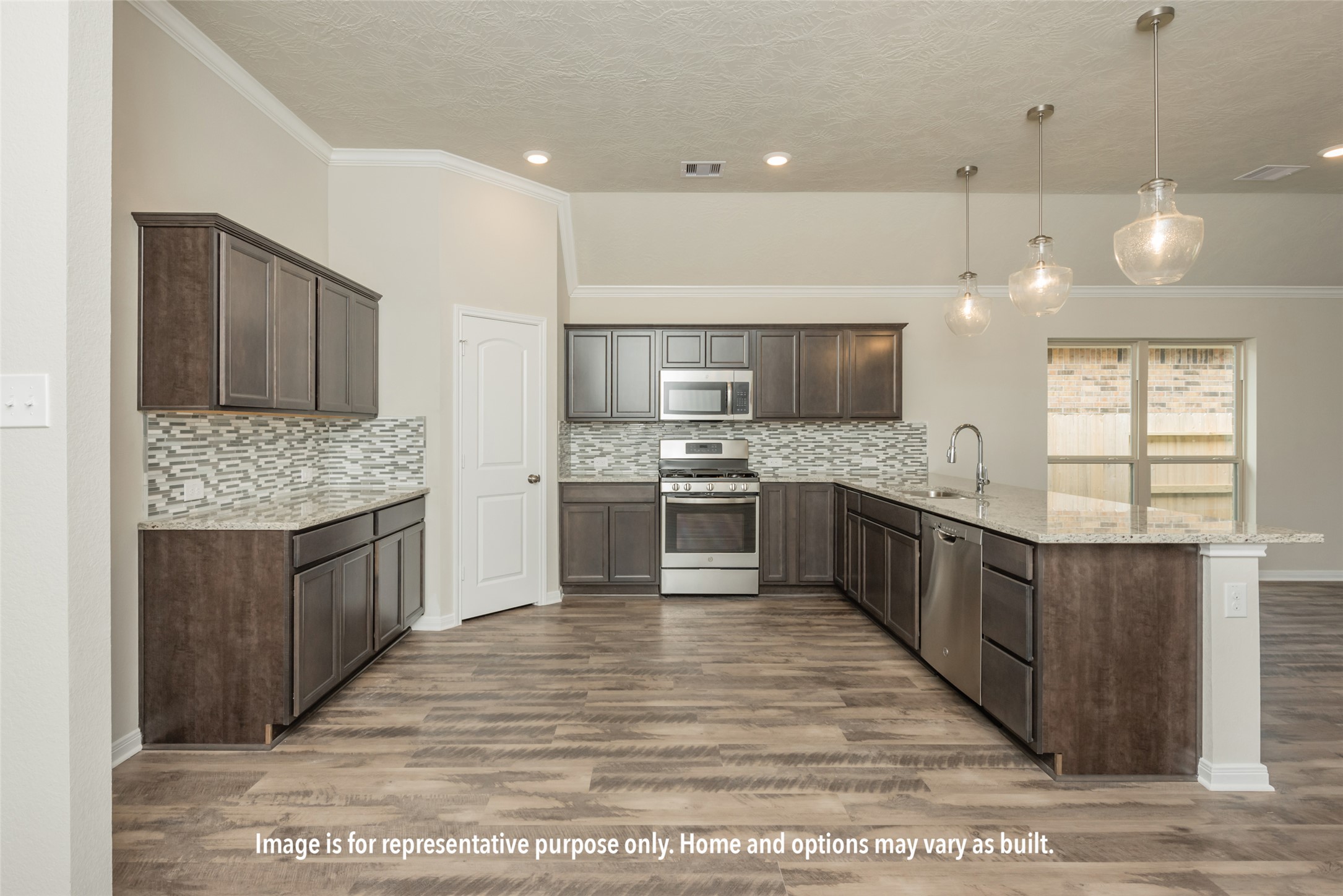220 Gus Loop Georgetown, TX 78626 - Photo 14 of 19 a large kitchen with a large counter top a sink stainless steel appliances and cabinets