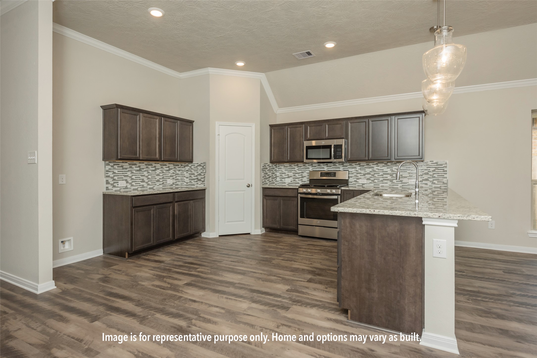 220 Gus Loop Georgetown, TX 78626 - Photo 15 of 19 a kitchen with stainless steel appliances kitchen island granite countertop a stove top oven a sink a counter space and cabinets