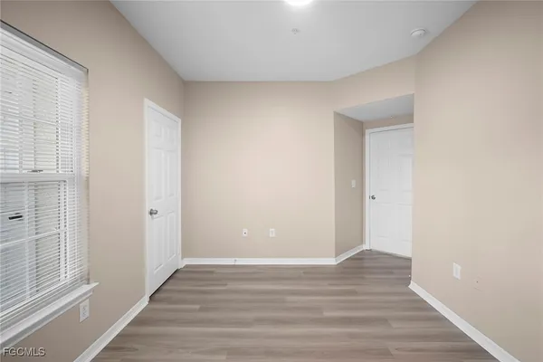 a view of wooden floor and windows in a room
