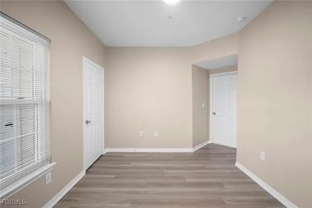 a view of wooden floor and windows in a room