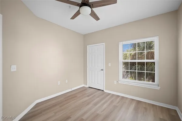 an empty room with windows and closet