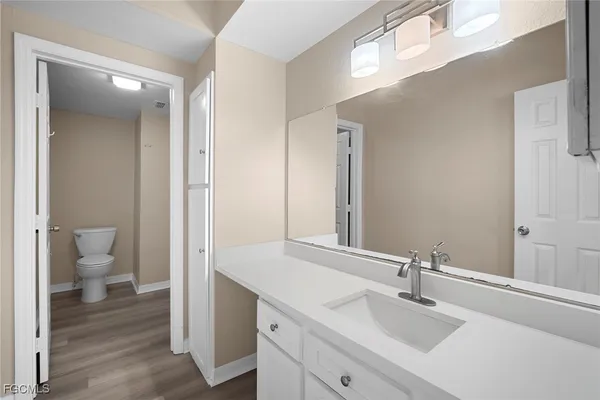 a bathroom with a sink and a mirror with toilet