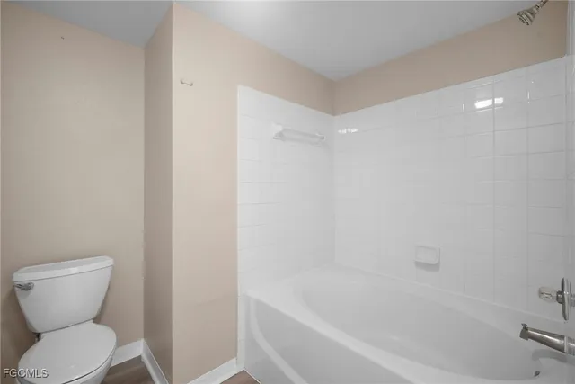 a bathroom with a toilet and a bathtub