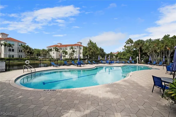 a view of a swimming pool and lounge chairs