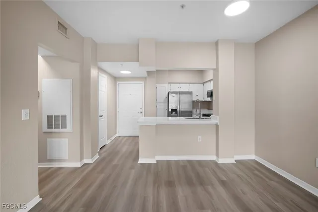 a view of kitchen and wooden floor