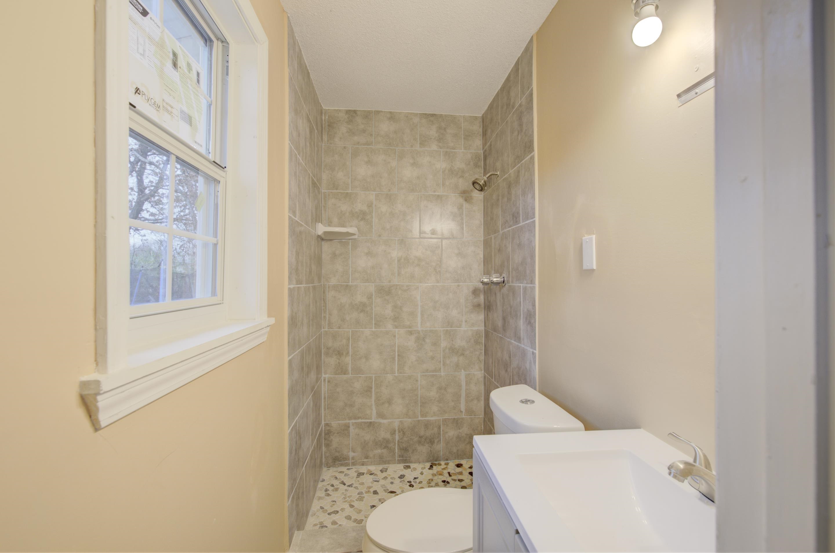 5546 Millbranch Road Memphis, TN 38116 - Photo 14 of 24 a bathroom with a toilet and a shower