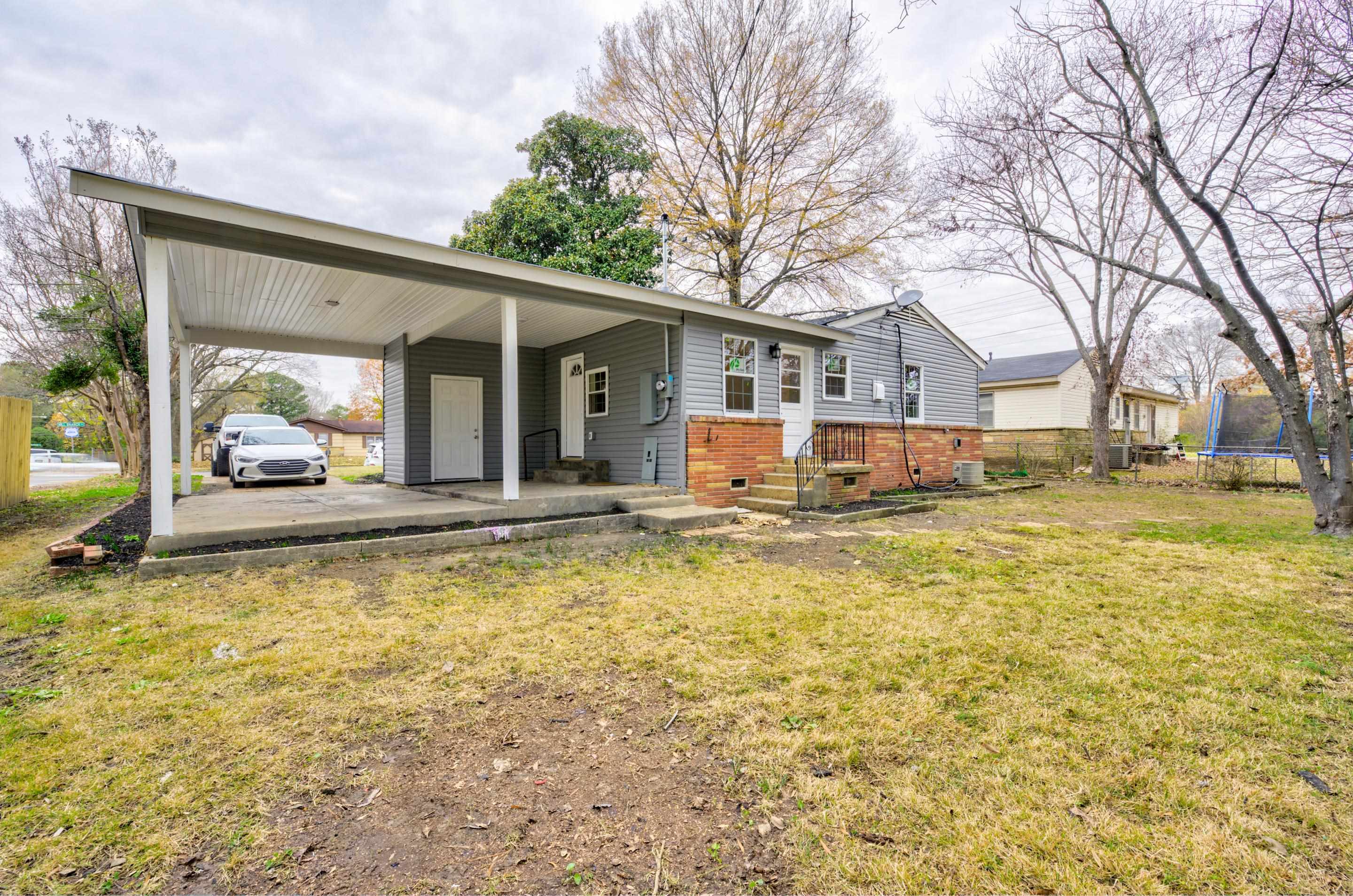 5546 Millbranch Road Memphis, TN 38116 - Photo 21 of 24 a view of a house with a swimming pool and a tree