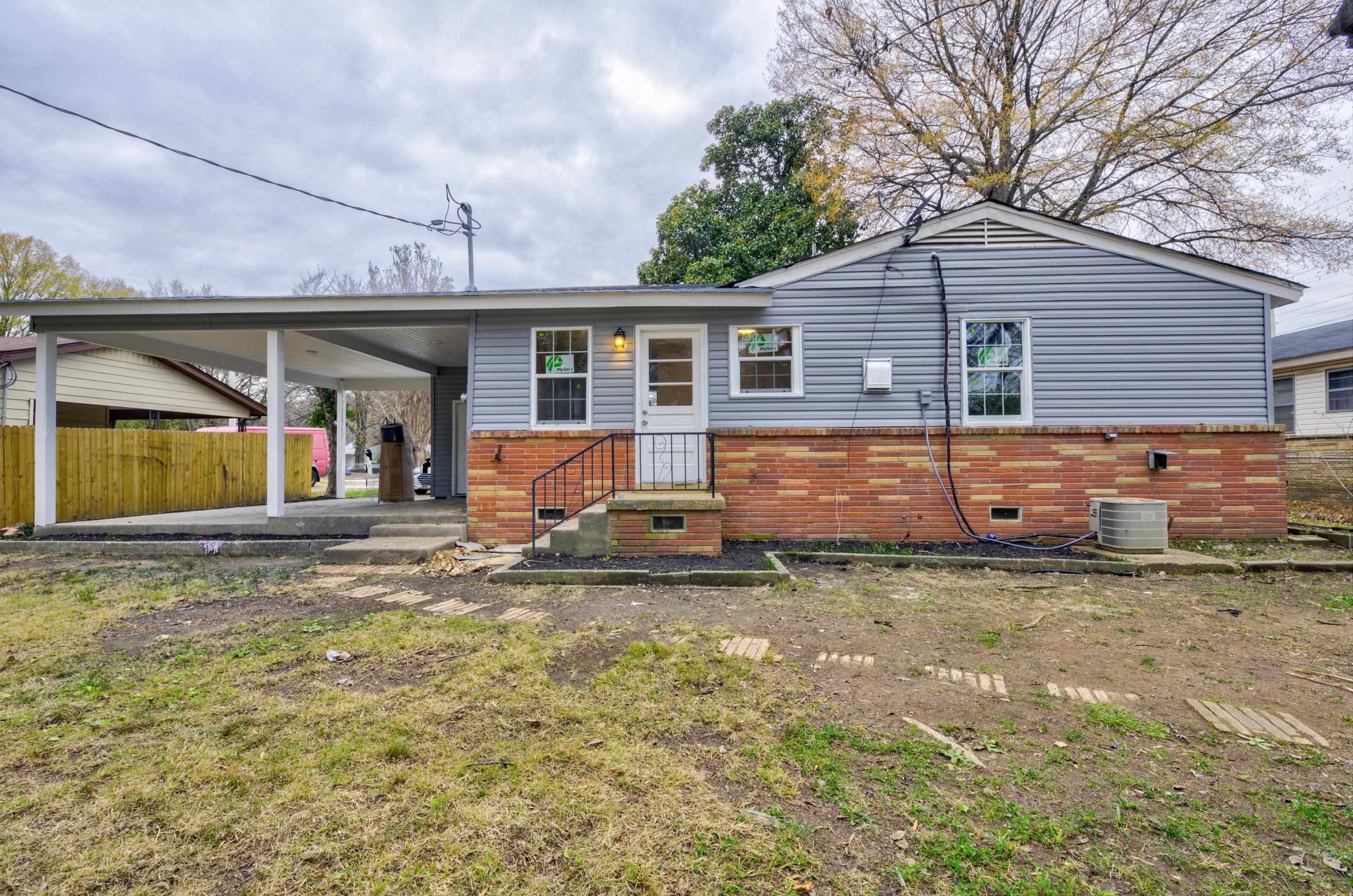 5546 Millbranch Road Memphis, TN 38116 - Photo 22 of 24 a view of a house with a yard