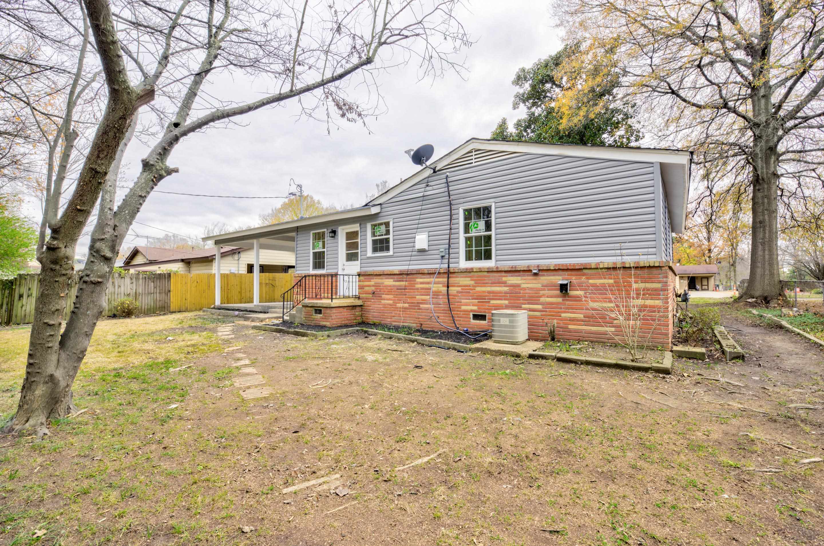 5546 Millbranch Road Memphis, TN 38116 - Photo 23 of 24 a view of a house with a yard covered in snow