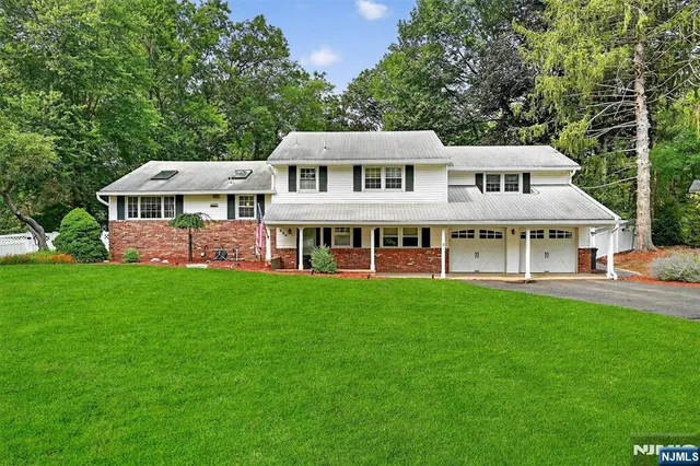 a front view of a house with a garden and porch