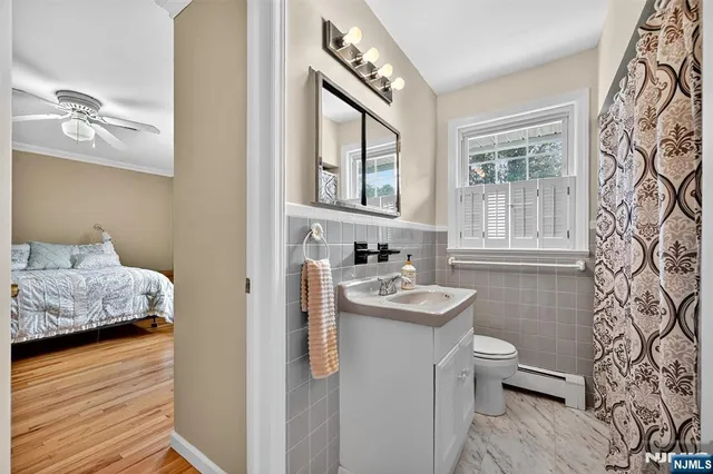 a en suite bathroom with a sink toilet and window
