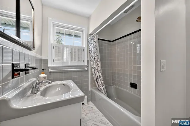 a bathroom with a sink a bathtub and a shower