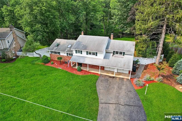 an aerial view of a house with swimming pool and big yard