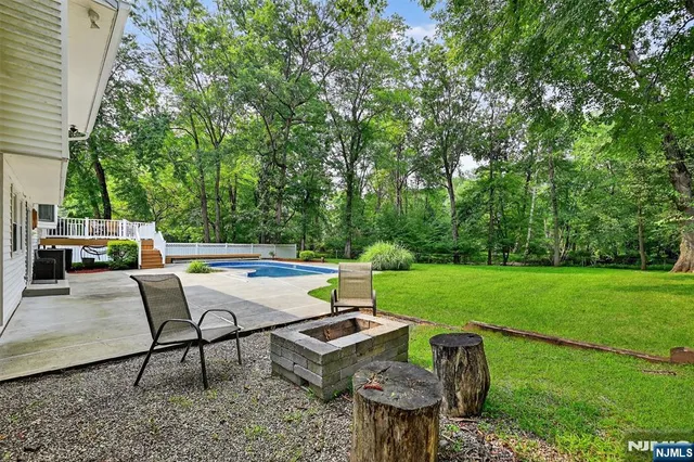 a view of a backyard with sitting area