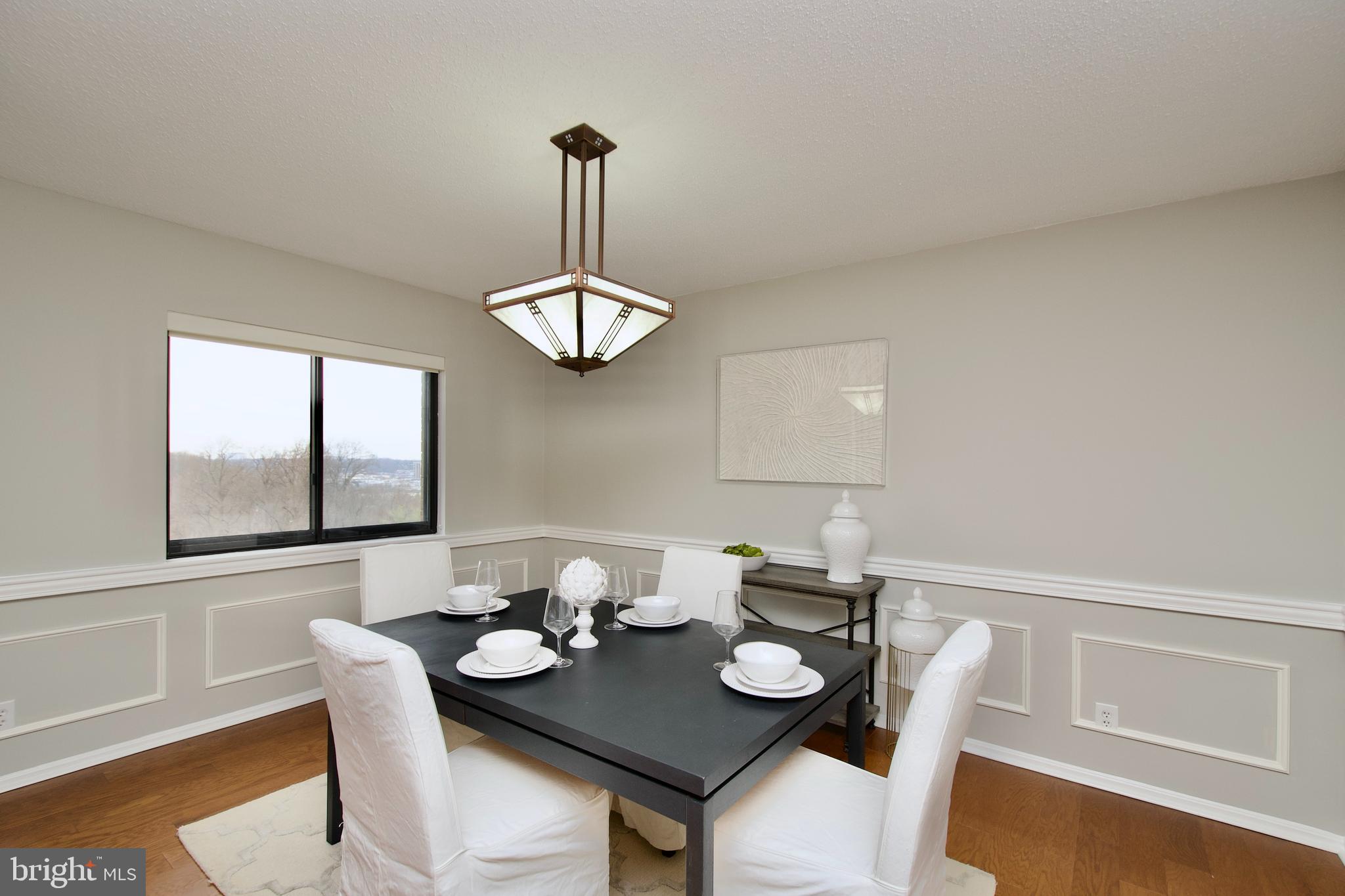 5902 Mt Eagle Drive, Unit 905 Alexandria, VA 22303 - Photo 11 of 55 a view of a dining room with furniture wooden floor and chandelier