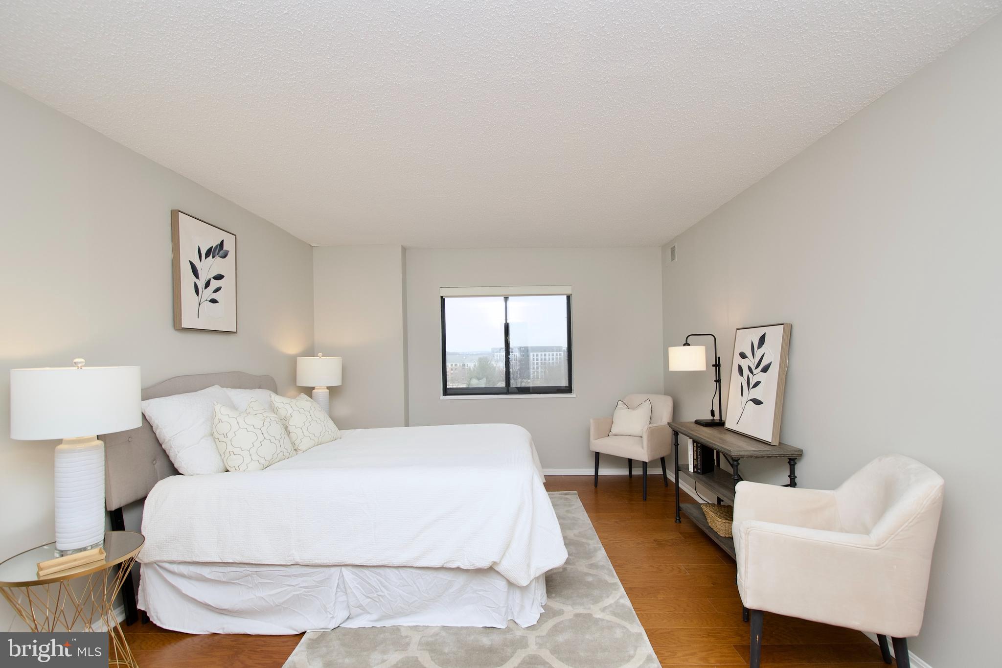 5902 Mt Eagle Drive, Unit 905 Alexandria, VA 22303 - Photo 14 of 55 a spacious bedroom with a bed and a couch