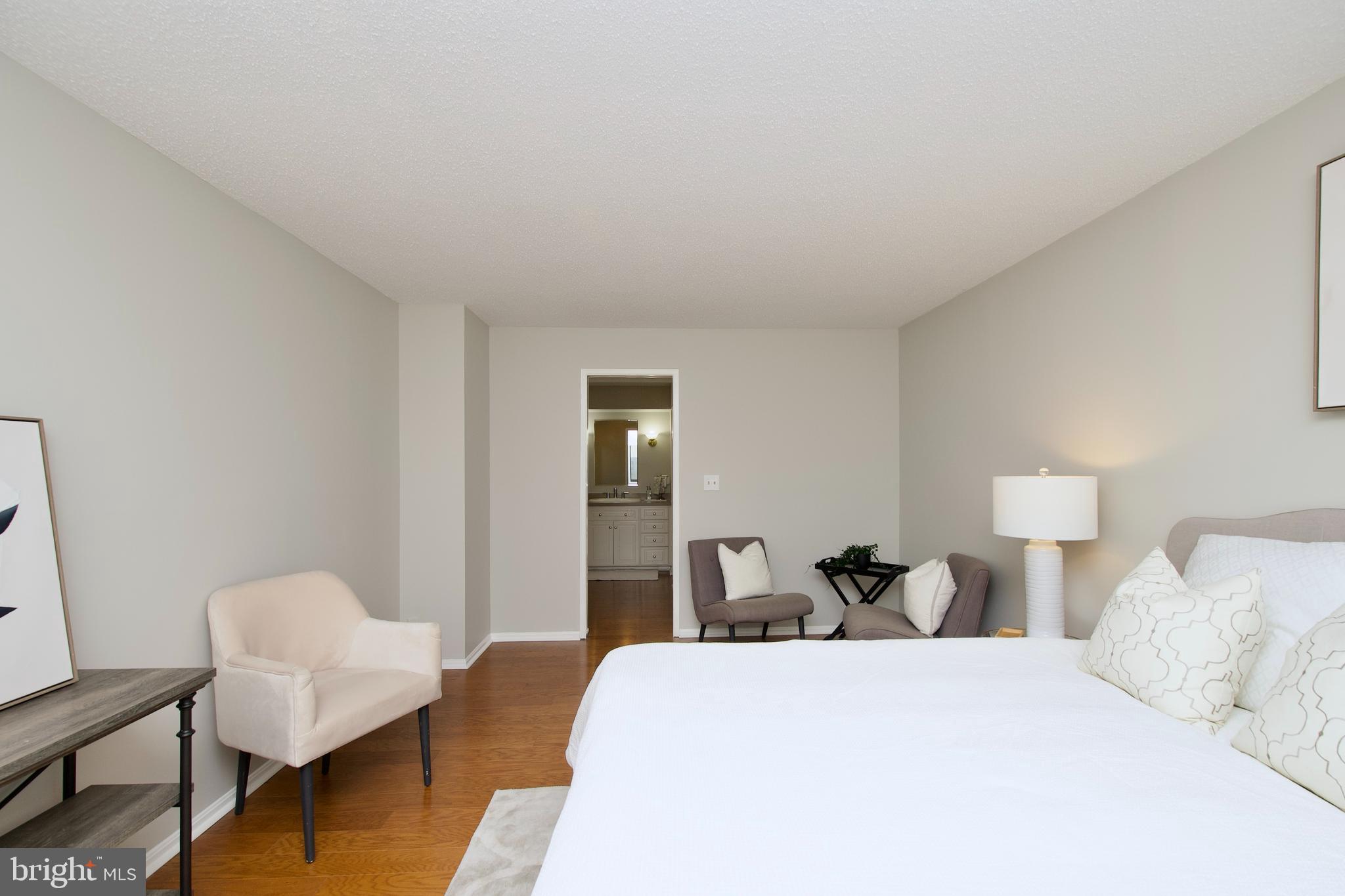 5902 Mt Eagle Drive, Unit 905 Alexandria, VA 22303 - Photo 17 of 55 a bedroom with a bed and chair