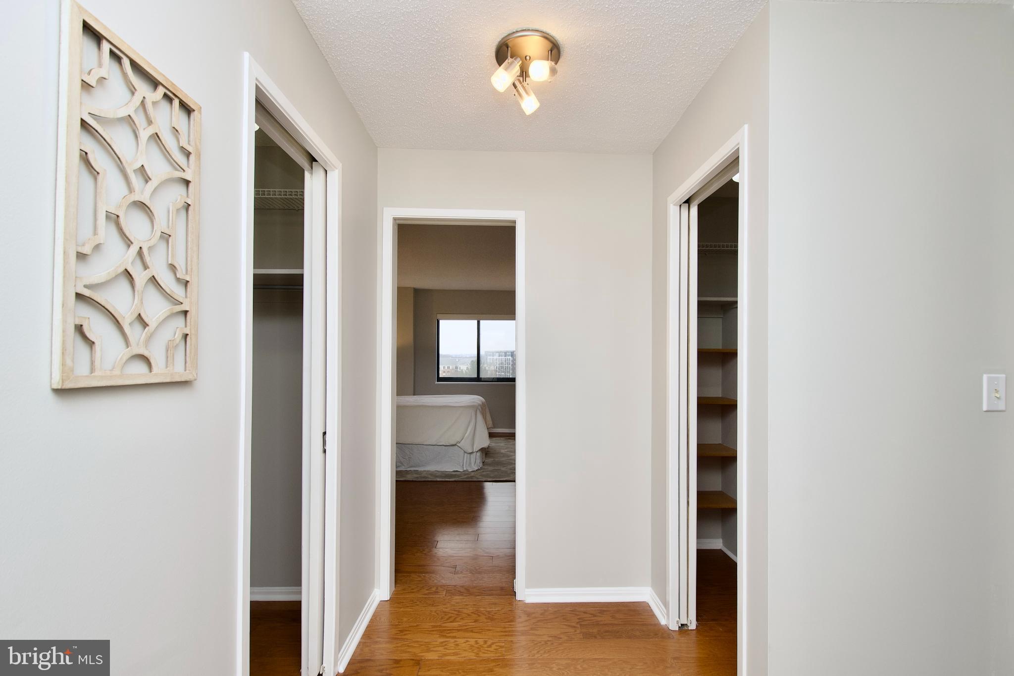5902 Mt Eagle Drive, Unit 905 Alexandria, VA 22303 - Photo 18 of 55 a view of a hallway with wooden floor and a living room