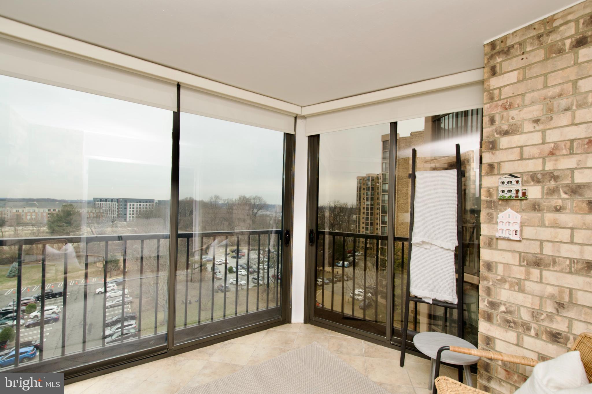 5902 Mt Eagle Drive, Unit 905 Alexandria, VA 22303 - Photo 3 of 55 a view of a balcony with chair and floor to ceiling window