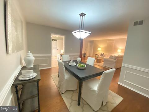 5902 Mt Eagle Drive, Unit 905 Alexandria, VA 22303 - Photo 48 of 55 a view of a dining room with furniture window and wooden floor
