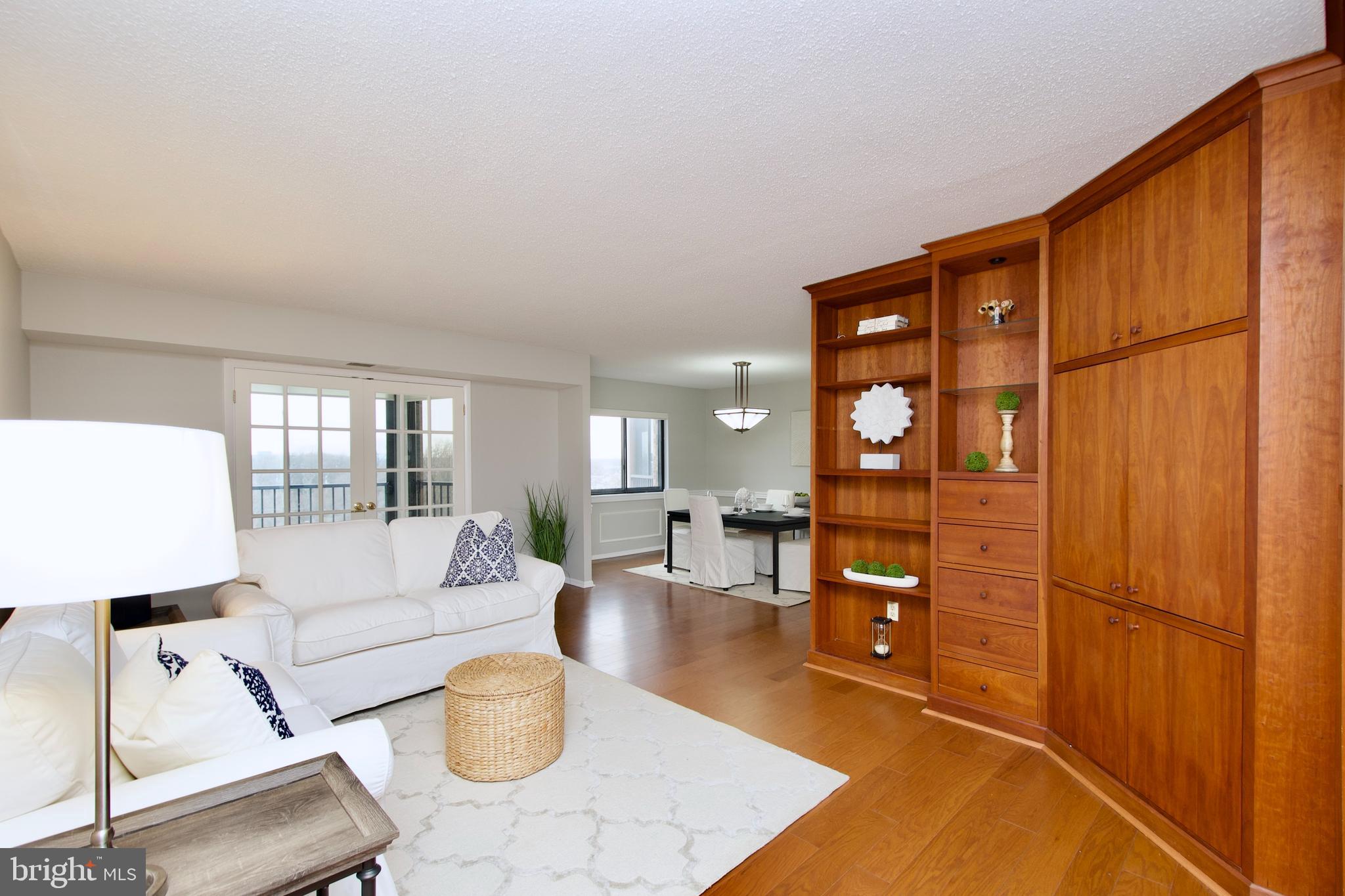 5902 Mt Eagle Drive, Unit 905 Alexandria, VA 22303 - Photo 5 of 55 a living room with furniture a wooden floor and a large window