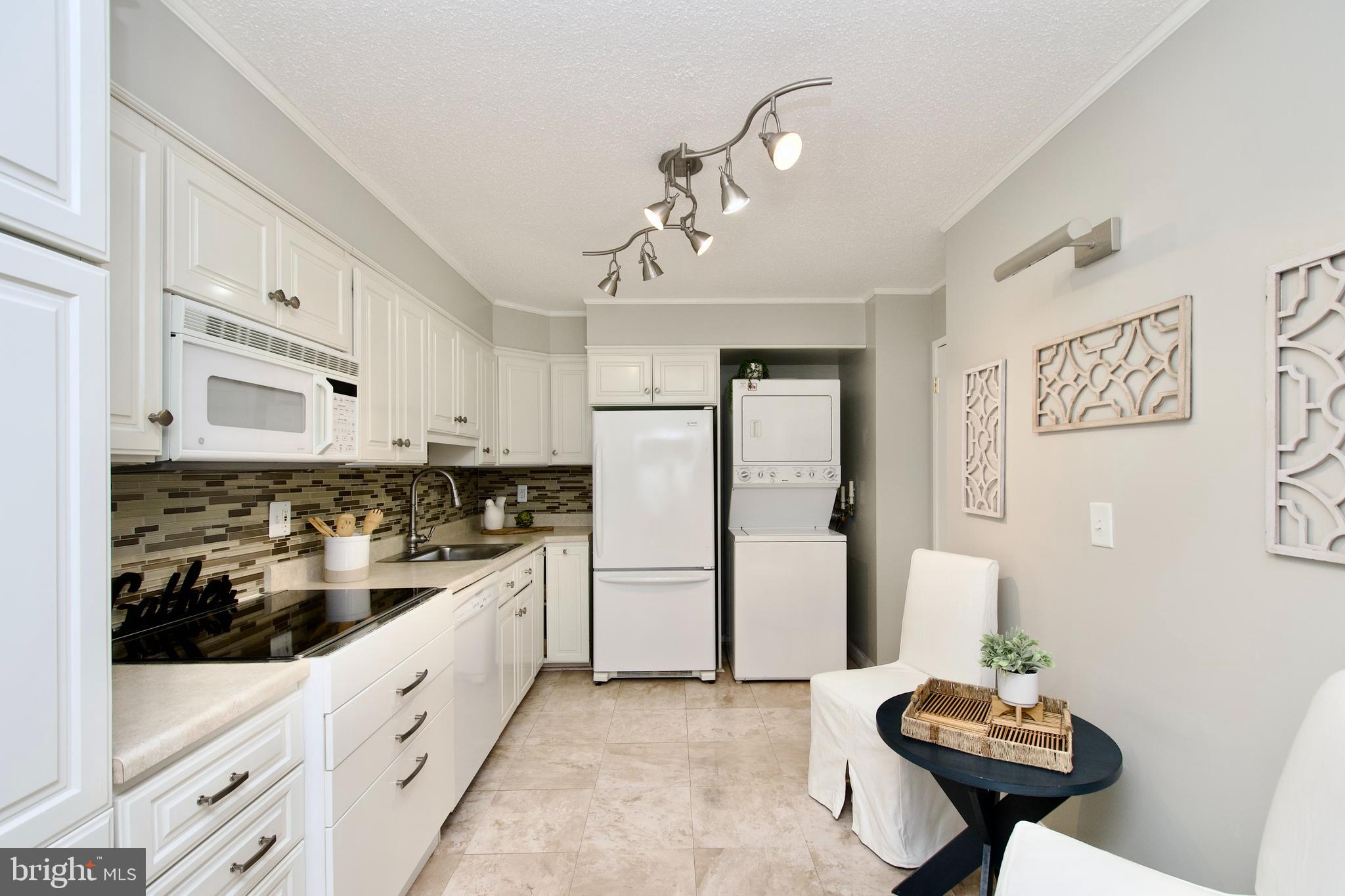 5902 Mt Eagle Drive, Unit 905 Alexandria, VA 22303 - Photo 10 of 55 a kitchen with stainless steel appliances a sink a stove a refrigerator and cabinets