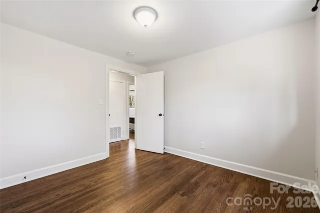 an empty room with wooden floor