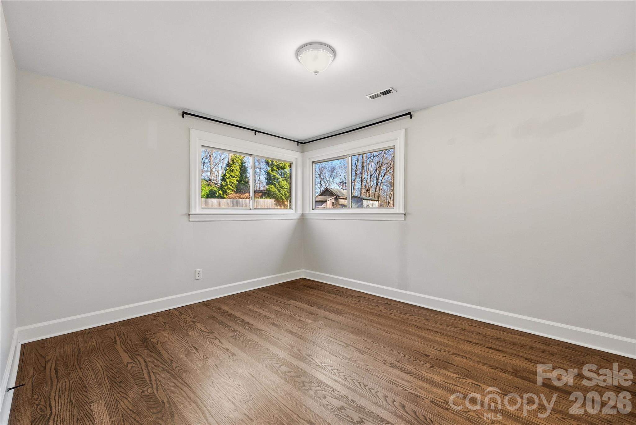 718 2nd Avenue Northeast Conover, NC 28613 - Photo 13 of 29 an empty room with wooden floor and windows