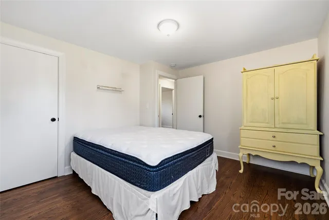 a room with a bed and cabinet