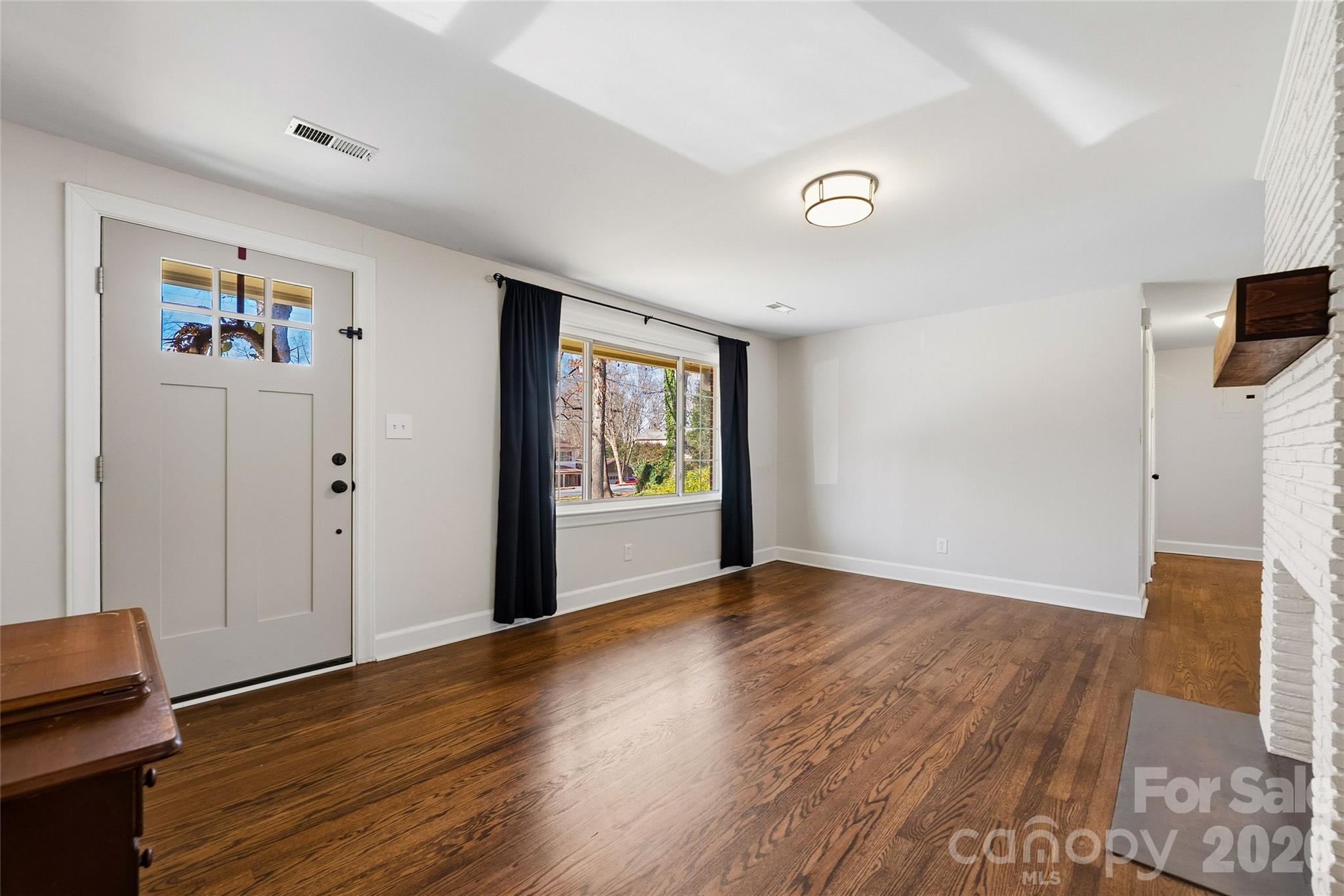 718 2nd Avenue Northeast Conover, NC 28613 - Photo 8 of 29 wooden floor in an empty room with a window