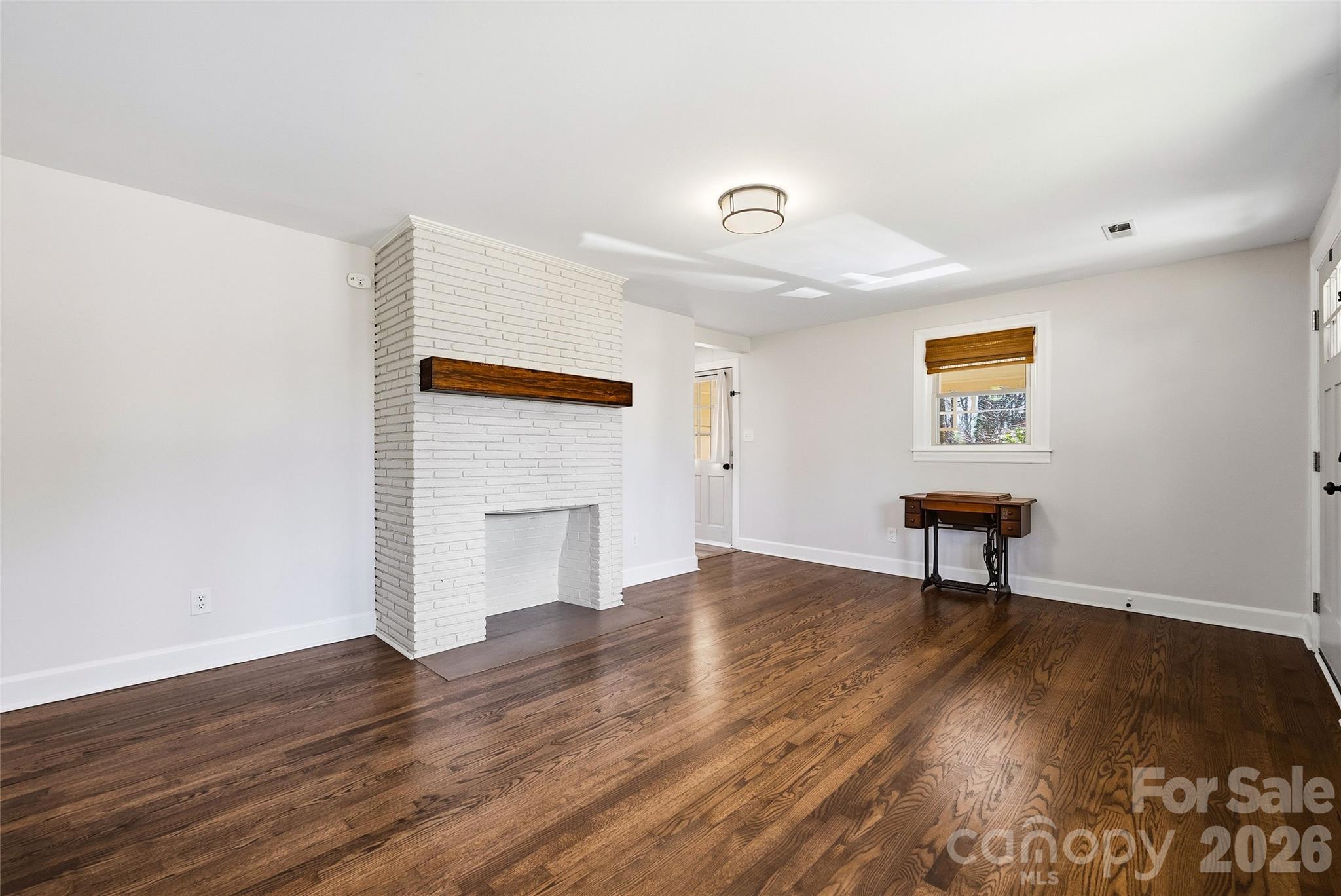 718 2nd Avenue Northeast Conover, NC 28613 - Photo 9 of 29 a view of a livingroom with wooden floor and a workspace