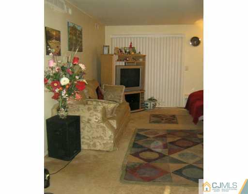 1929 Raspberry Court Edison, NJ 08817 - Photo 2 of 8 a living room with furniture and flowers