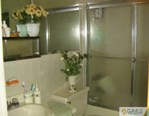 1929 Raspberry Court Edison, NJ 08817 - Photo 7 of 8 a bathroom with a sink and mirror
