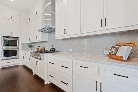 a kitchen with center island table and chairs in it