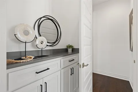a bathroom with a double vanity sink a mirror and a bathtub
