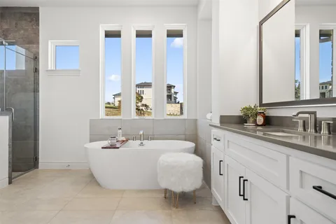 a spacious bathroom with double sink and a mirror