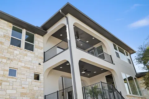 an aerial view of a house with a garden and lake view