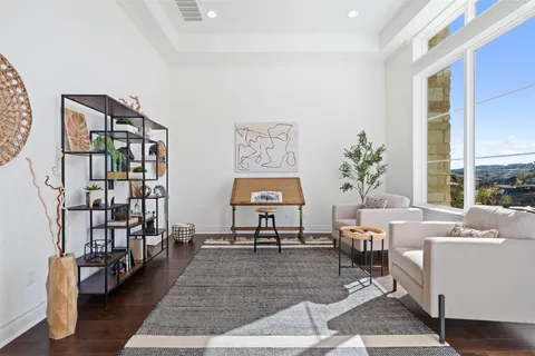 a living room with furniture and a book shelf