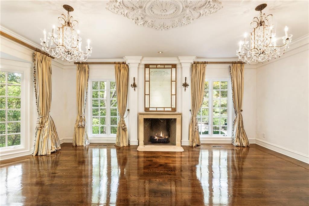 2485 West Wesley Road Northwest Atlanta, GA 30327 - Photo 16 of 84 a view of a livingroom with a fireplace wooden floor and windows